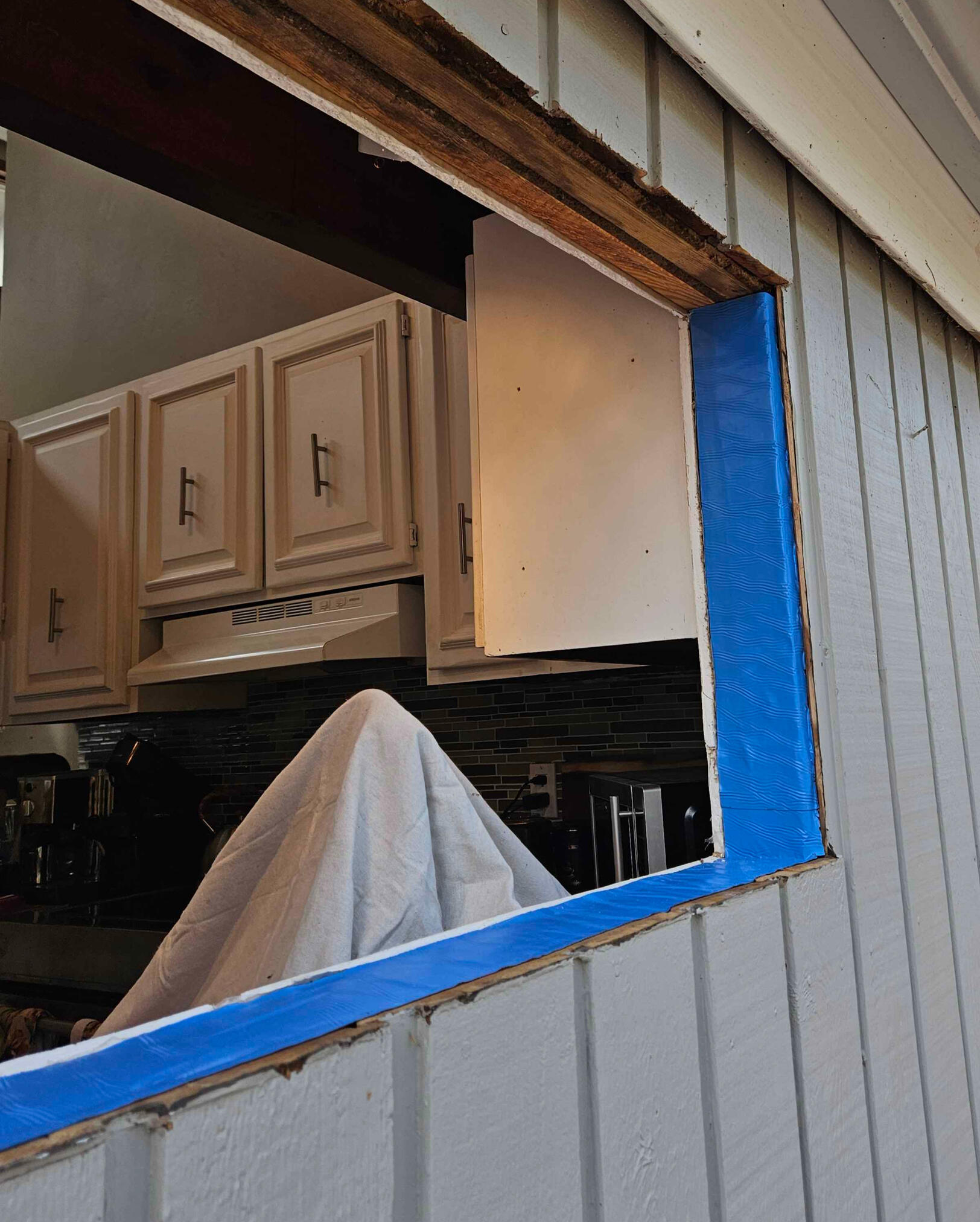 The rotted material was repaired, and the framing was protected against future moisture intrusion using membrane tape.